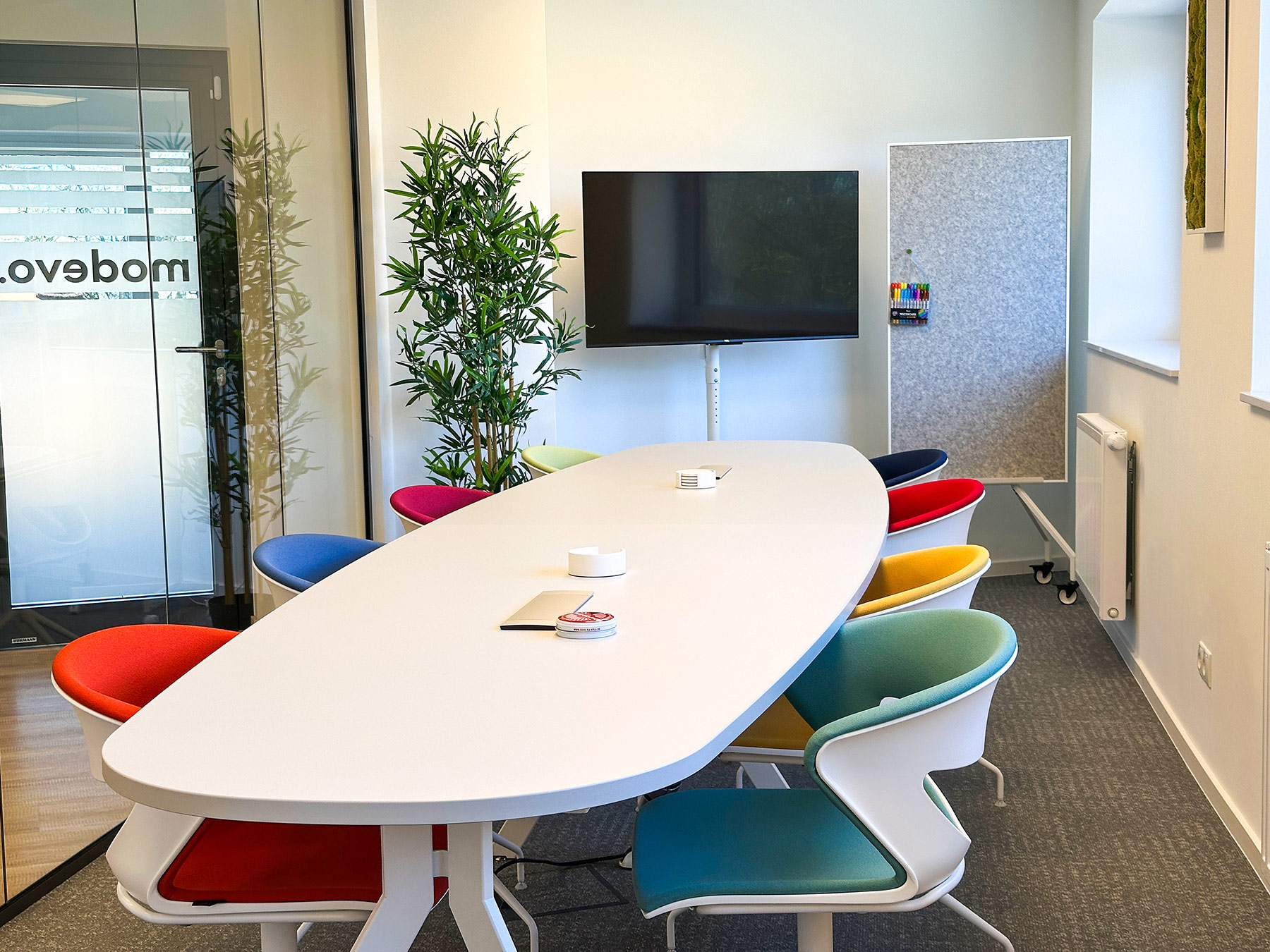 Heller Meetingraum mit Konferenztisch und Stühlen